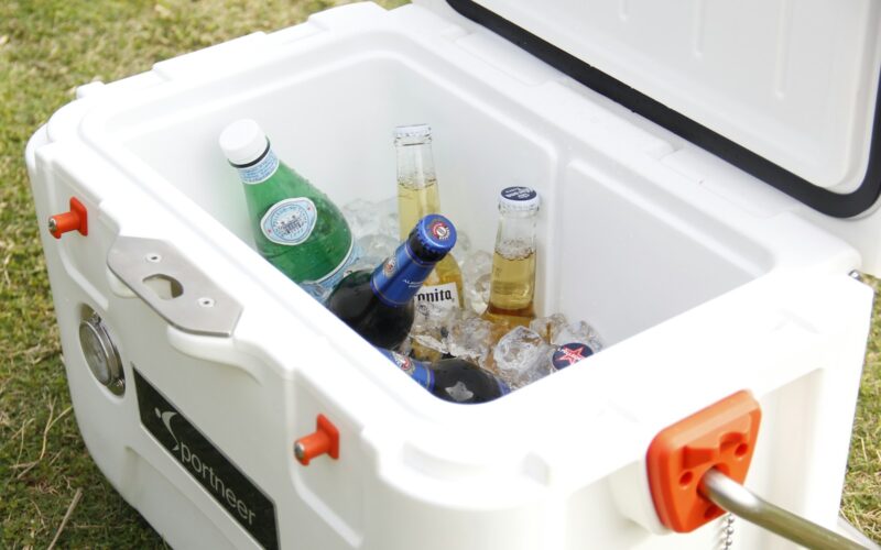 white ice cooler with assorted-brand bottle lot